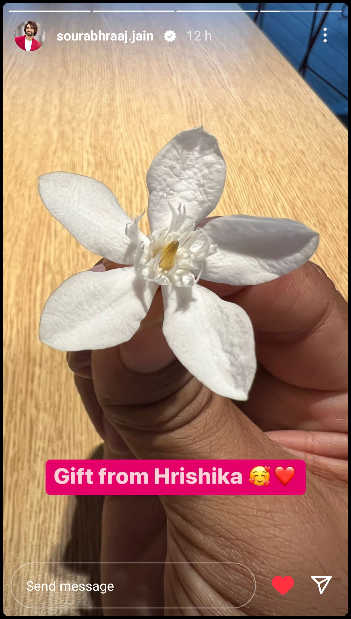 A photograph of a delicate white flower with five petals (perhaps gardenia) posted as an Instagram story by Sourabh Raaj Jain with the text "Gift from Hrishika"