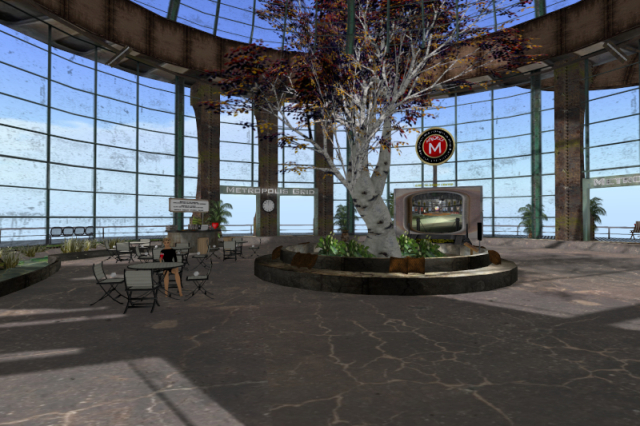 Part of level 3 of the Metropolis welcome building, the main landing level. It is covered by a steel-supported glass cupola. There is a tree growing in the middle. Behind it, slightly to the left, is the walk-in teleporter to level 2 with various other teleporters; above it is a rotating sign with the Metropolis logo on it. To the left, there are multiple tables with chairs surrounding them; the old welcome greeter Bertha Sr. is sitting on one of them as a static puppet. Behind them, there is the semi-circular info desk with the most recent Bertha as an NPC. The signs above the exits to the platform surrounding the cupola read, "Metropolis Grid."
