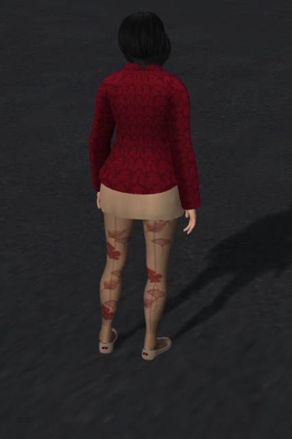 Self-portrait in today's autumn outfit. As always, I'm wearing my black hair in an almost-shoulder-length bob. I'm wearing a dark red long-sleeved button-down shirt with a fancy medium red pattern on it, a straight beige micro-miniskirt, sheer nylon tights with grey seams on the rear side and various red autumn leaves printed on it and a pair of beige Mary Janes with the creator's label as a red rectangle on the back. I've turned my back on the camera. The background is plain grey asphalt.