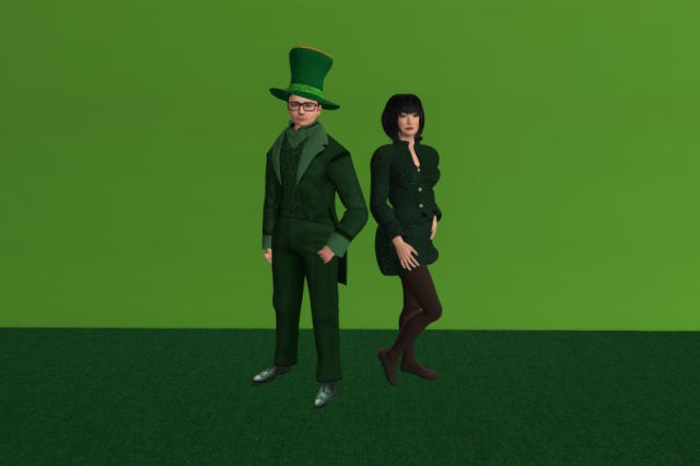 Juno and I posting in a room in front of a lime-green wall and with a dark green carpet. I am standing on the left, wearing a green leprechaun-style top hat, a green suit with a matching green brocade vest and green full-brogue shoes. Juno is standing on the right, wearing a green jacket with small white dots, a barely visible black top underneath, a short green skirt with small white dots, sheer black tights, black flat shoes and a golden ring with a green gem. She has also put on green eyeshadow, bronze blush, red-brown lipstick and forest green nail polish.