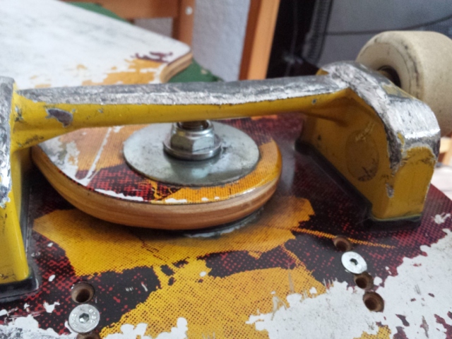 A truck of a streetboard. The material is heavily used due to grinds