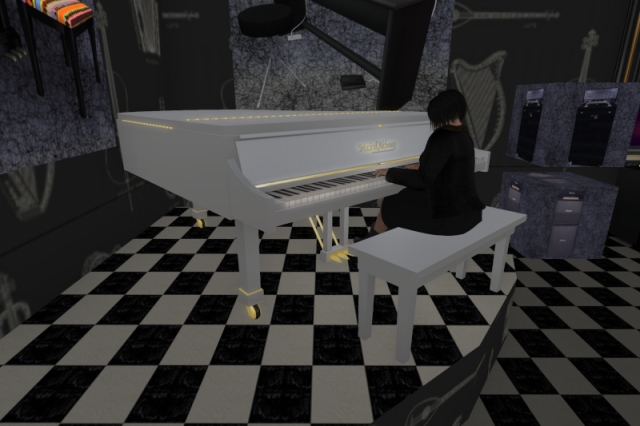 Me playing a white grand piano that's standing on a pedestal with chequered black and white tiles, surrounded by various sales boxes with musical equipment inside and a wallpaper with musical instruments printed on it