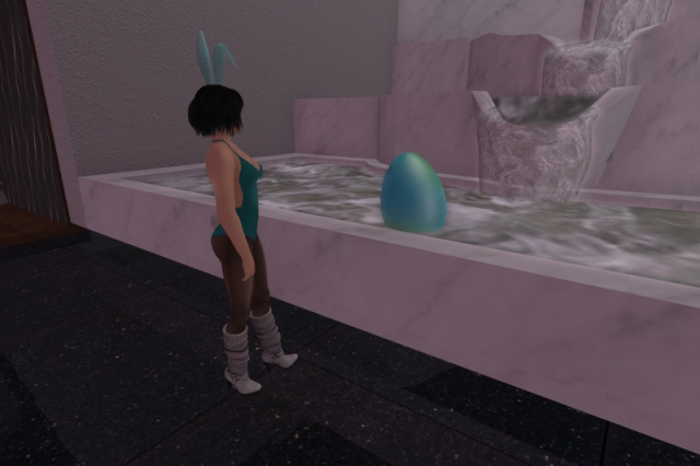 Me inside the freebie store at Meow, standing in front of a fountain made of white marble. In the basin, right in front of me, stands a large teal Easter egg. One of my bunny ears is deliberately crooked forward.